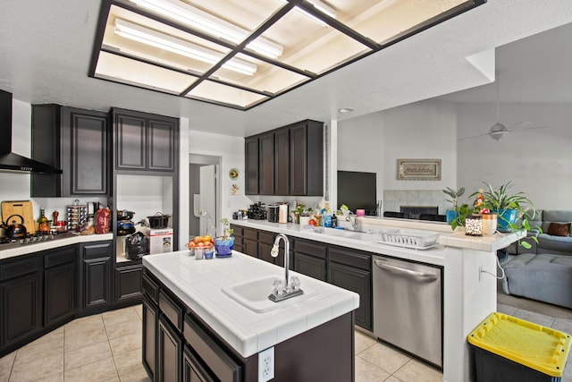 kitchen featuring ceiling fan, sink, stainless steel appliances, light tile patterned floors, and a kitchen island