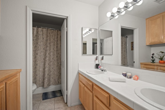 bathroom featuring toilet, vanity, and tile patterned floors