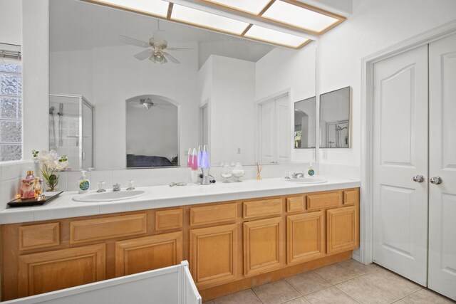 bathroom featuring ceiling fan, tile patterned flooring, vanity, and an enclosed shower