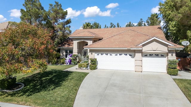 view of front of home with a front lawn and a garage