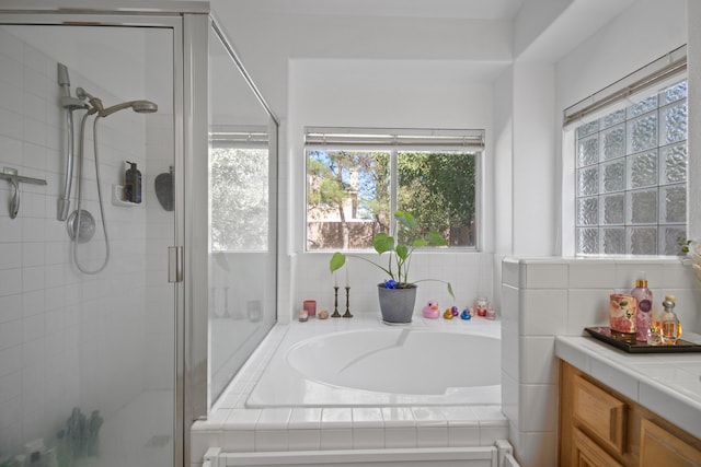 bathroom with vanity, plus walk in shower, and tasteful backsplash