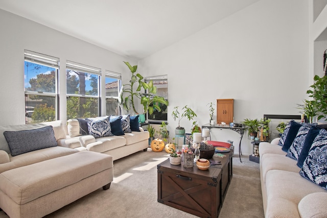 living room featuring light colored carpet and lofted ceiling