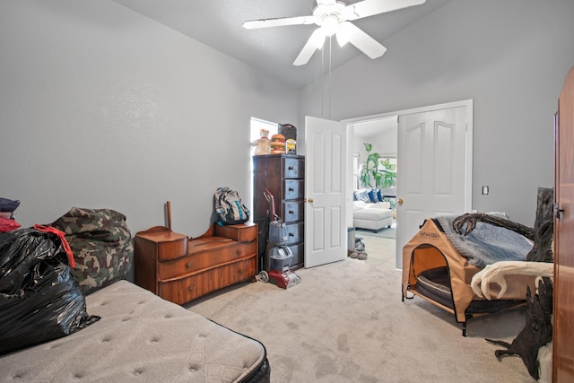 carpeted bedroom featuring ceiling fan, a closet, and high vaulted ceiling