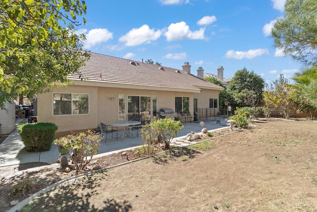 rear view of property with a patio area