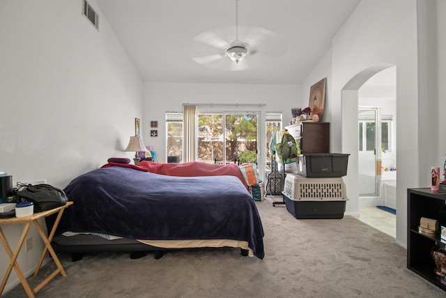 bedroom with light carpet, connected bathroom, ceiling fan, and lofted ceiling