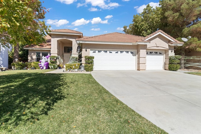 view of front of home with a front yard and a garage