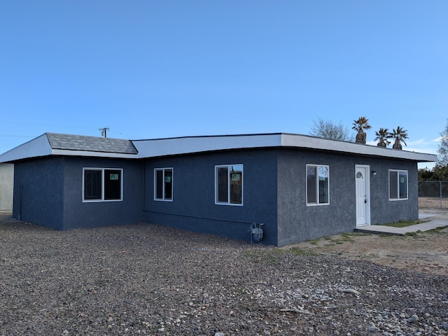 rear view of property with stucco siding