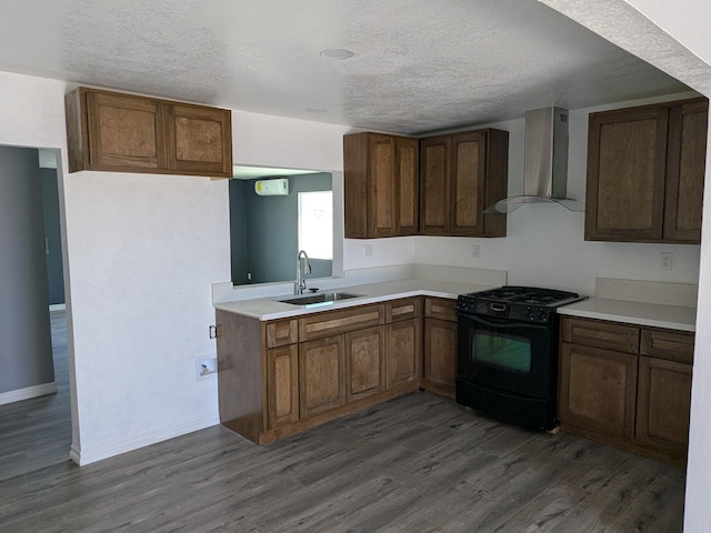 kitchen with wall chimney range hood, dark wood-style flooring, a sink, and black range with gas stovetop