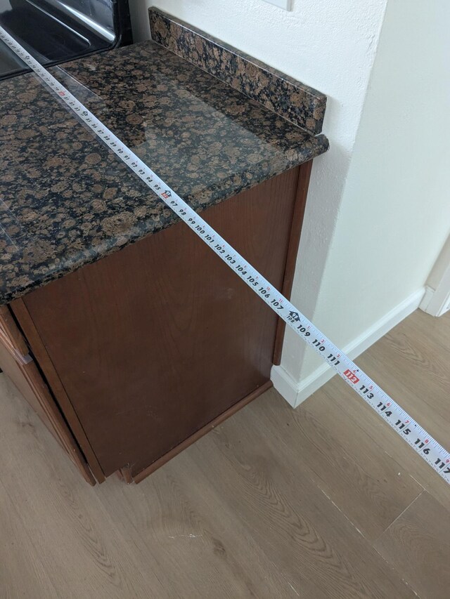 details featuring baseboards and wood finished floors