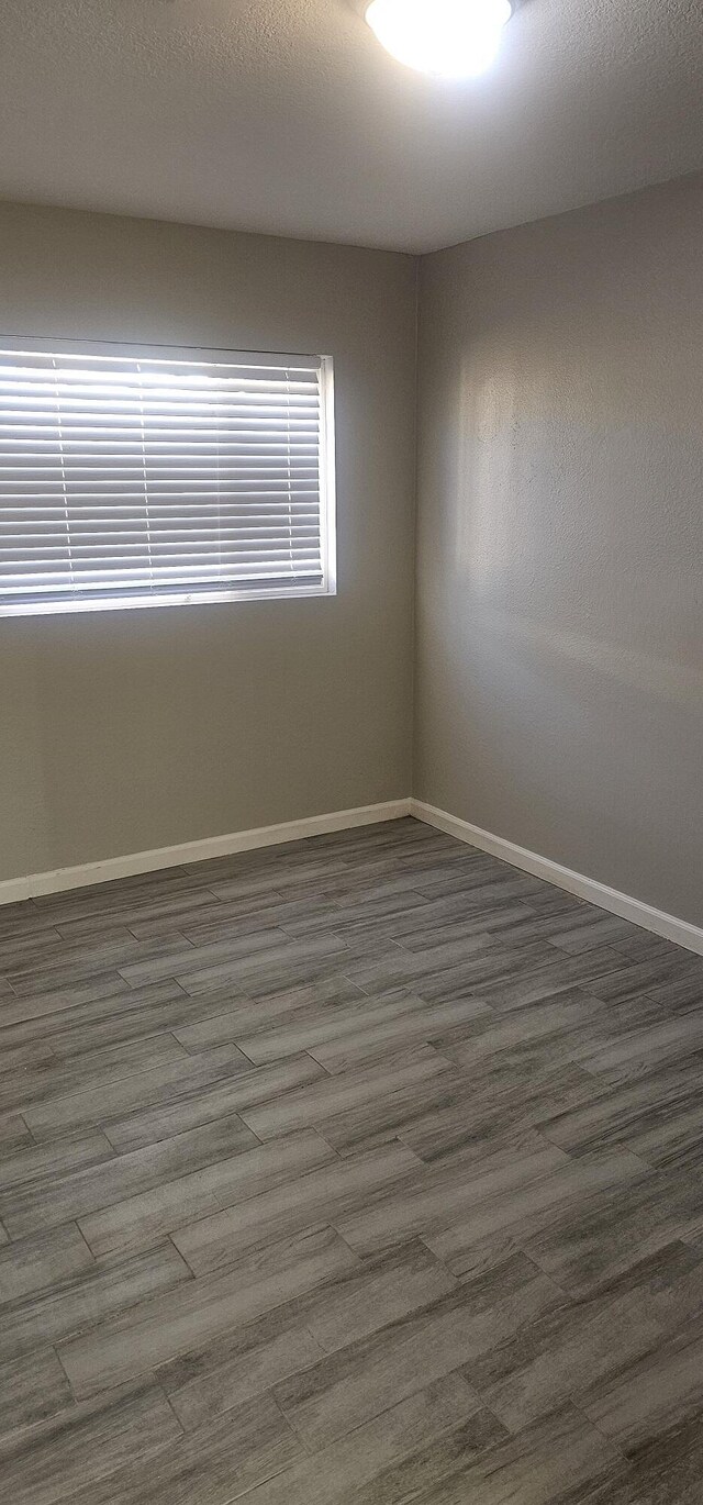 empty room with dark hardwood / wood-style floors