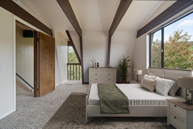 carpeted bedroom with beam ceiling