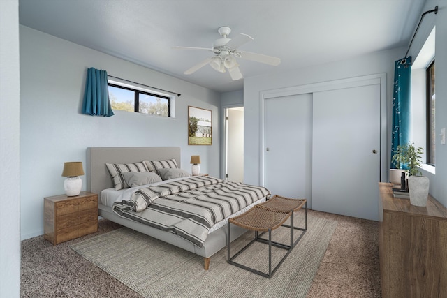 carpeted bedroom featuring ceiling fan and a closet
