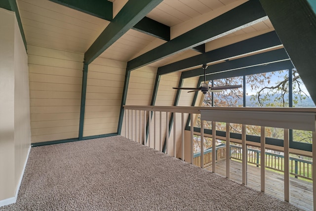 interior space featuring vaulted ceiling with beams, carpet flooring, and wooden ceiling