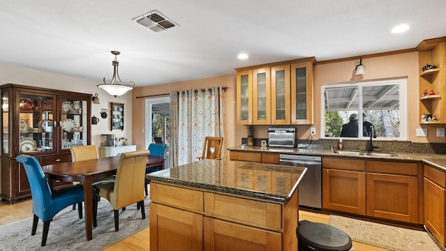 kitchen with light wood-type flooring, a center island, a sink, visible vents, and dishwasher