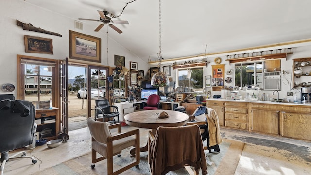 dining area with a ceiling fan, concrete flooring, high vaulted ceiling, and visible vents