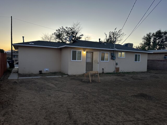 15284 Carol St, Mojave, CA 93501 - back of property at dusk featuring stucco siding