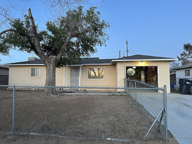 15284 Carol St, Mojave, CA 93501 - view of front of house with stucco siding, a fenced front yard, and concrete driveway