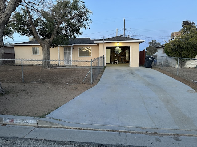 15284 Carol St, Mojave, CA 93501 - ranch-style home with stucco siding, a fenced front yard, concrete driveway, and a shingled roof