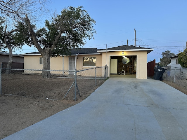 15284 Carol St, Mojave, CA 93501 - ranch-style home with stucco siding, concrete driveway, a fenced front yard, and roof with shingles