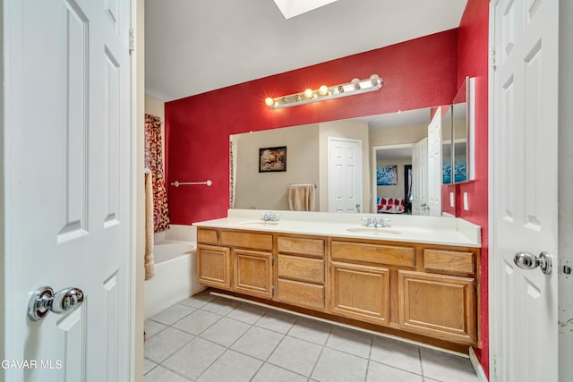 3628 Marilynn St, Lancaster, CA 93536 - bathroom with tile patterned flooring, double vanity, a bathtub, and a skylight