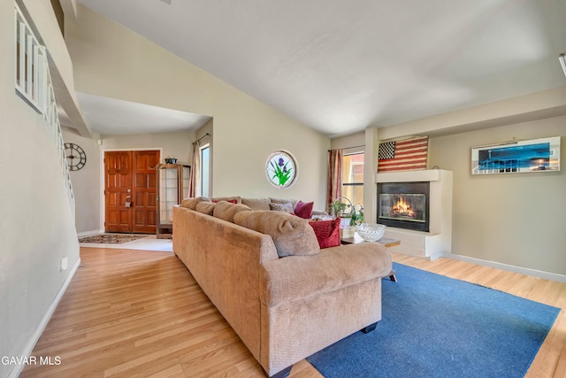 3628 Marilynn St, Lancaster, CA 93536 - living area featuring light wood-style floors, a glass covered fireplace, and vaulted ceiling