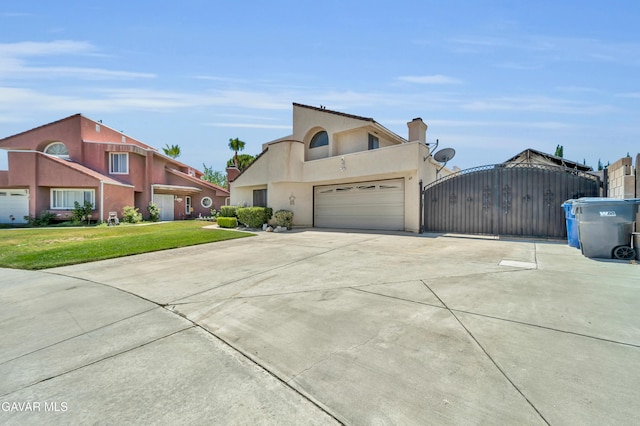 3628 Marilynn St, Lancaster, CA 93536 - view of front of property featuring a gate, driveway, a garage, stucco siding, and a front yard