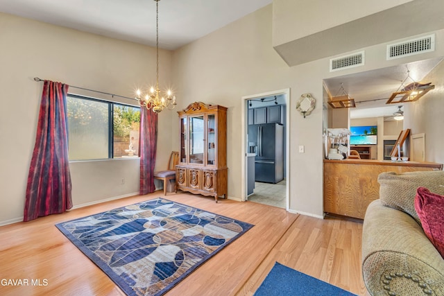 3628 Marilynn St, Lancaster, CA 93536 - living room featuring wood finished floors, a high ceiling, and a chandelier