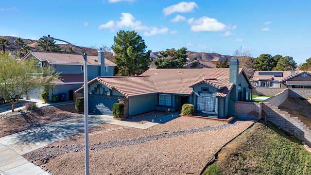 view of front facade featuring a mountain view and a garage