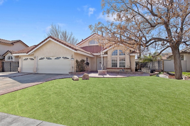 mediterranean / spanish-style home with a garage, concrete driveway, stucco siding, fence, and a front yard