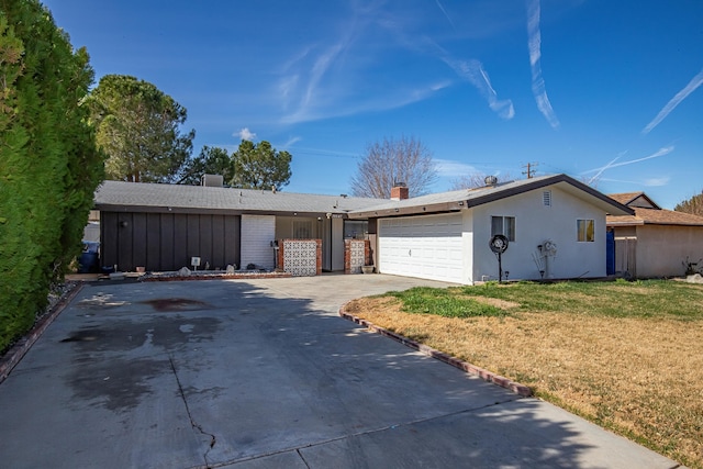 ranch-style house with a garage and a front lawn