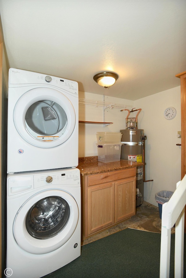 laundry room with cabinets, stacked washing maching and dryer, and water heater