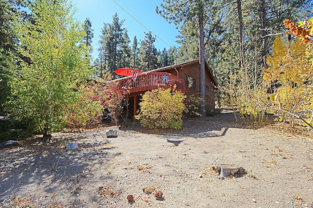 view of side of home featuring a wooden deck