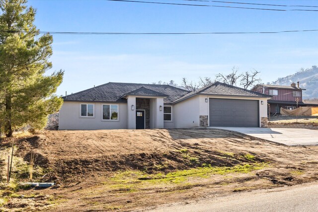 view of front of house featuring a mountain view and a garage