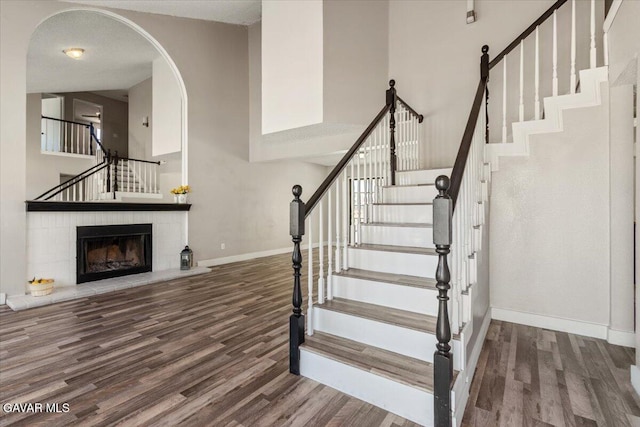 37623 E 49th St, Palmdale, CA 93552 - staircase with wood finished floors, a high ceiling, and a fireplace