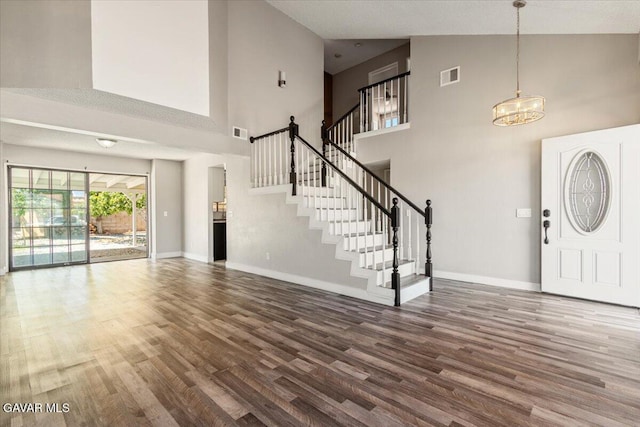 37623 E 49th St, Palmdale, CA 93552 - foyer with high vaulted ceiling, wood finished floors, a chandelier, and stairway