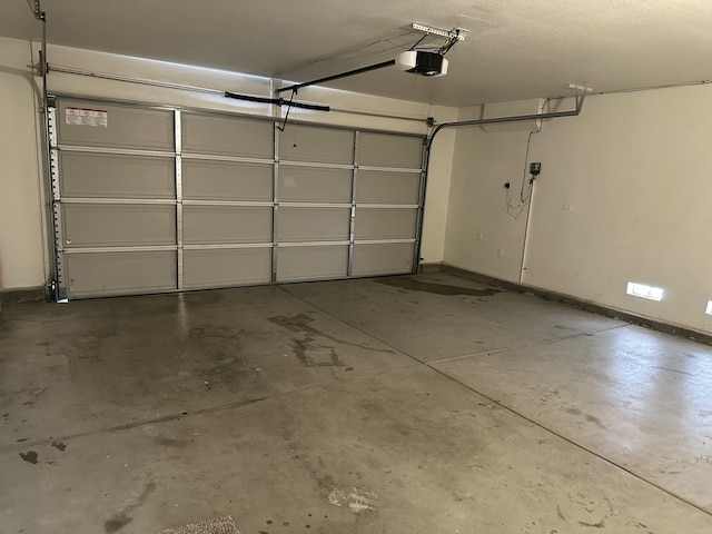 45559 Robinson Dr, Lancaster, CA 93535 - garage with a garage door opener and baseboards
