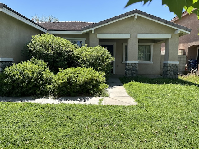 45559 Robinson Dr, Lancaster, CA 93535 - view of front facade with stucco siding, a front yard, and stone siding