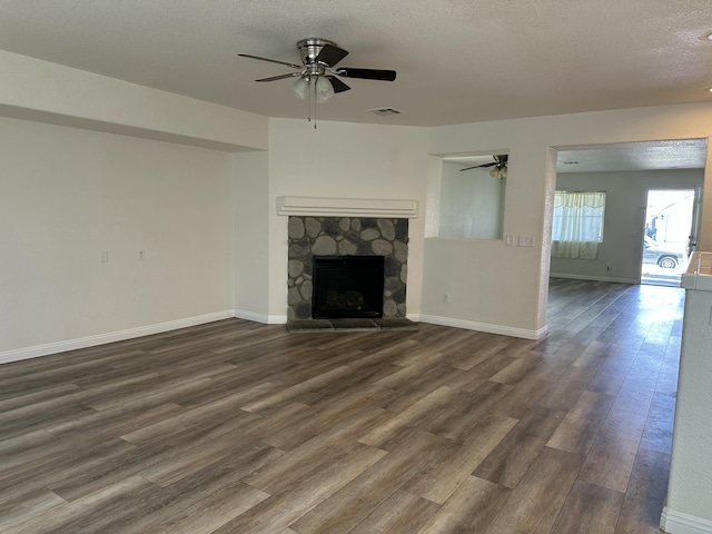 45559 Robinson Dr, Lancaster, CA 93535 - unfurnished living room with a ceiling fan, wood finished floors, a fireplace, and a textured ceiling