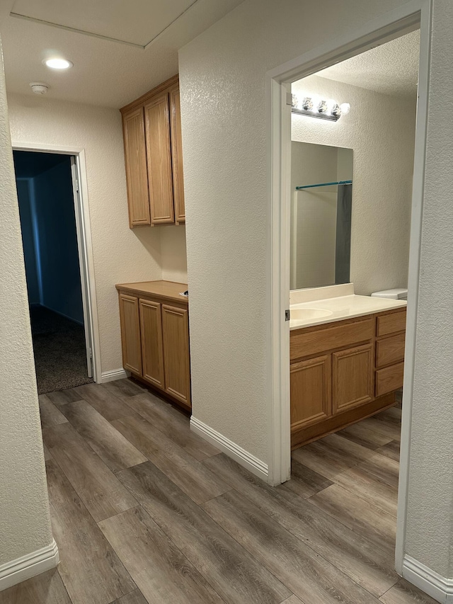 45559 Robinson Dr, Lancaster, CA 93535 - corridor featuring dark wood-style flooring and a textured wall