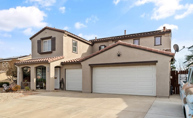 mediterranean / spanish home with a garage