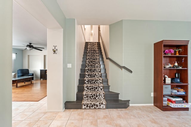 stairs with ceiling fan and tile patterned floors