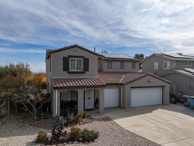 view of front of property with a garage and solar panels