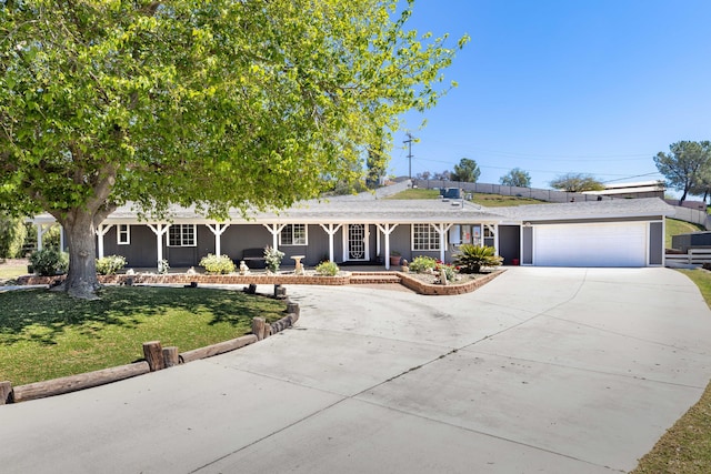32722 Wagon Wheel Rd, Agua Dulce, CA 91390 - ranch-style home featuring covered porch, curved driveway, a garage, and a front yard