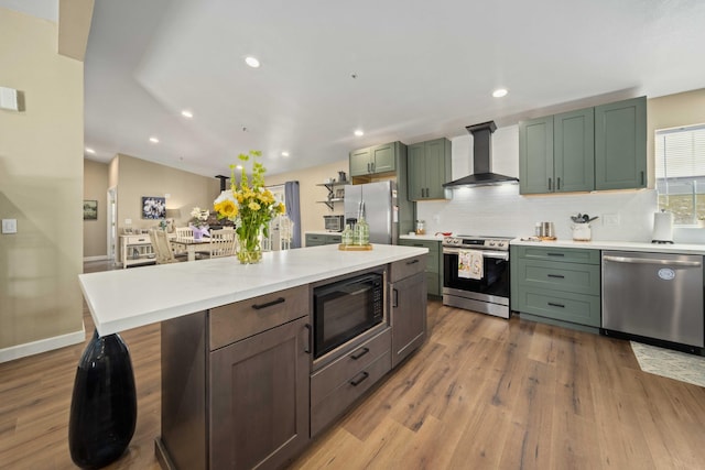 32722 Wagon Wheel Rd, Agua Dulce, CA 91390 - kitchen featuring appliances with stainless steel finishes, wall chimney range hood, wood finished floors, tasteful backsplash, and light countertops