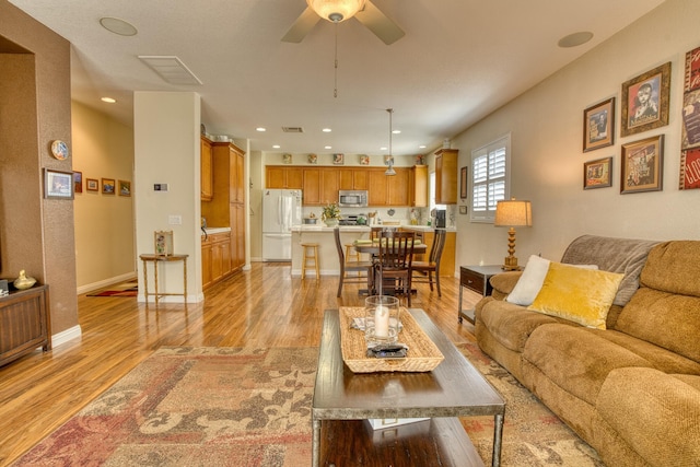 3216 Janine Ave, Rosamond, CA 93560 - living room with light wood-style flooring, a ceiling fan, baseboards, and recessed lighting