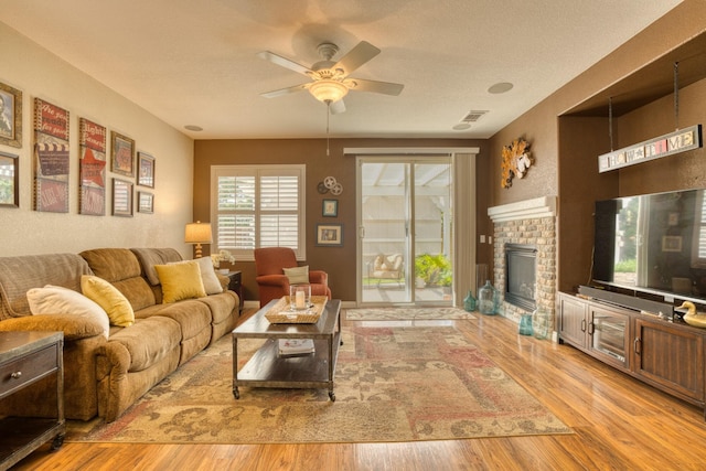 3216 Janine Ave, Rosamond, CA 93560 - living room with ceiling fan, wood finished floors, and a brick fireplace