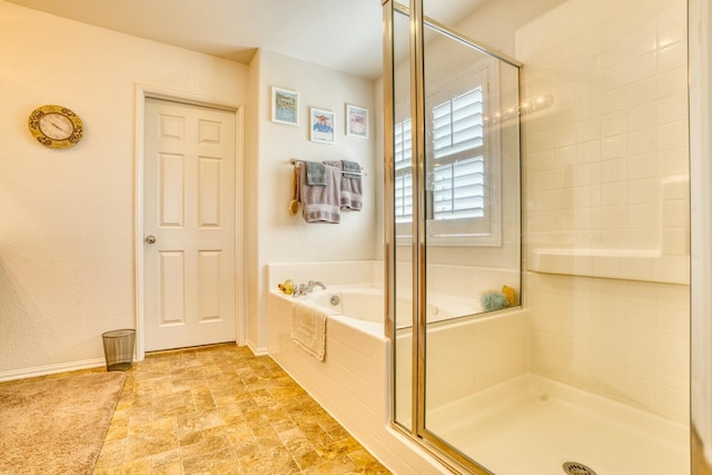 3216 Janine Ave, Rosamond, CA 93560 - full bathroom featuring a stall shower, a bath, and baseboards