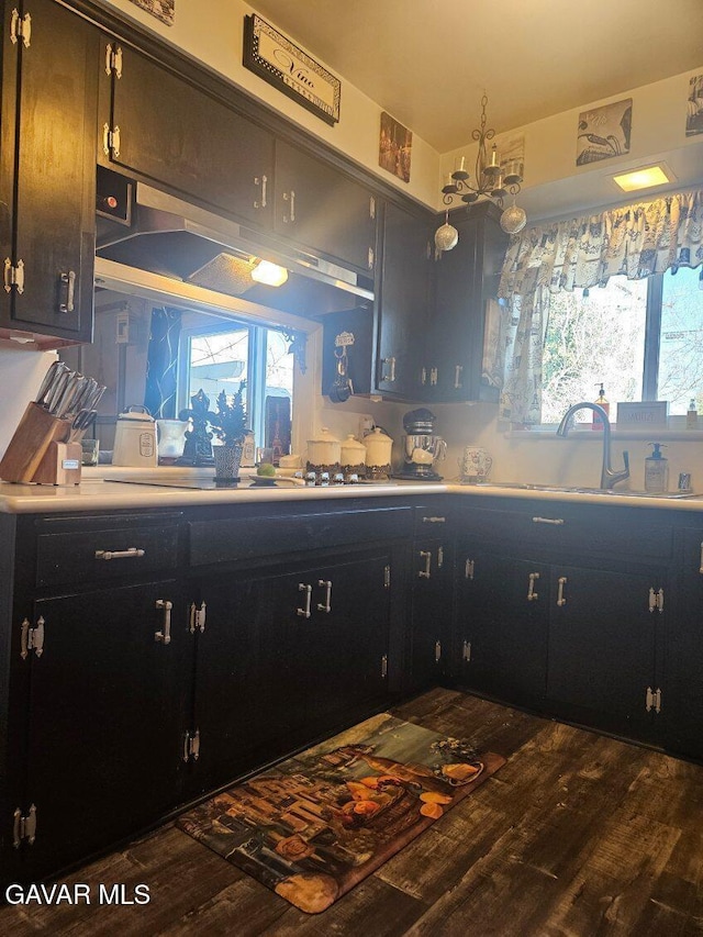 1283 W Lancaster Blvd, Lancaster, CA 93534 - kitchen with wood finished floors, cooktop, light countertops, and dark cabinets