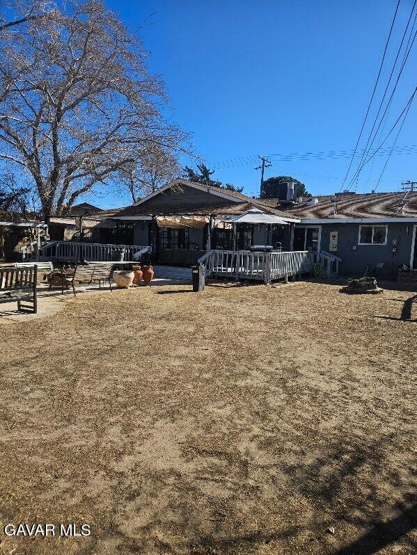 1283 W Lancaster Blvd, Lancaster, CA 93534 - rear view of property with a deck