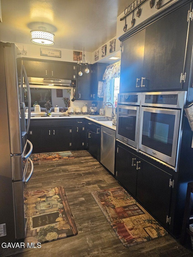 1283 W Lancaster Blvd, Lancaster, CA 93534 - kitchen featuring stainless steel appliances, dark wood-type flooring, light countertops, and dark cabinetry